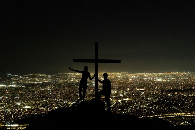 People stand atop of Manquehuito hill in Santiago, Chile, Monday, February 24, 2025. (Photo by Matias Basualdo/AP Photo)