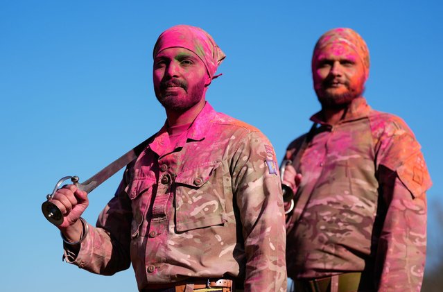 Gunner Vikramieet Singh (left) and Corporal Nishan Singh pose for a photograph holding traditional Sikh swords after practicing Gatka, a traditional Sikh martial art, during the Holla Mahalla Sikh military festival, at the Aldershot Garrison, Hampshire, UK on Tuesday, March 18, 2025. The centuries old Hola Mahalla festival celebrates Sikh martial traditions, and promotes courage, preparation, and readiness. (Photo by Andrew Matthews/PA Images via Getty Images)