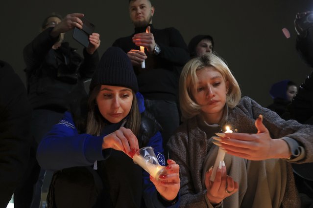 People light candles in memory of the victims of the terrorist attack in Moscow, in the center of in the center of Simferopol, in Russian-held Crimea, Friday, March 22, 2024. Several gunmen have burst into a big concert hall in Moscow and fired automatic weapons at the crowd, injuring an unspecified number of people and setting a massive blaze in an apparent terror attack days after President Vladimir Putin cemented his grip on the country in a highly orchestrated electoral landslide. (Photo by AP Photo)
