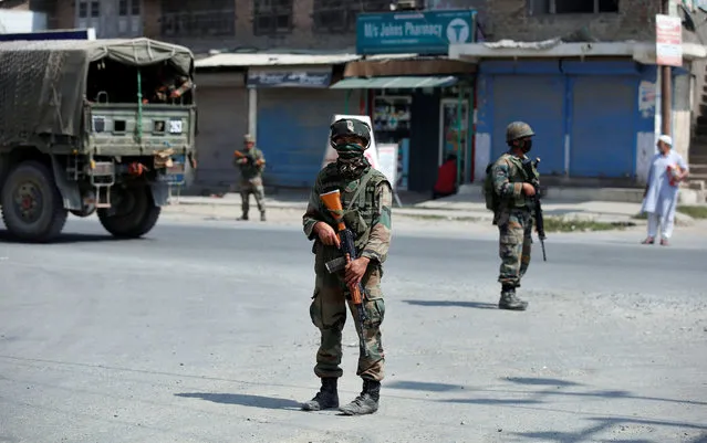 Indian army soldiers stand guard on a street on the outskirts of Srinagar, India, September 21, 2016. (Photo by Danish Ismail/Reuters)