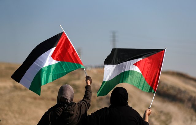 Palestinians wave flags during a protest against Israeli decision to evict Palestinian Bedouin community of Khan al-Ahmar, located between the West Bank city of Jericho and Jerusalem near the Israeli settlement of Maale Adumim, 23 January 2023. The Israeli government needs to inform the Israeli high court of its position on the issue of the evictions that has been approved by the Israeli High Court of Justice on February 2017, to demolish the village of Khan al-Ahmar with its 40 houses, a mosque and a primary school that serves a number of other Bedouin communities located on Area C near East Jerusalem, in order to re-locate them near the West Bank town of Abu Diess. (Photo by Atef Safadi/EPA/EFE/Rex Features/Shutterstock)