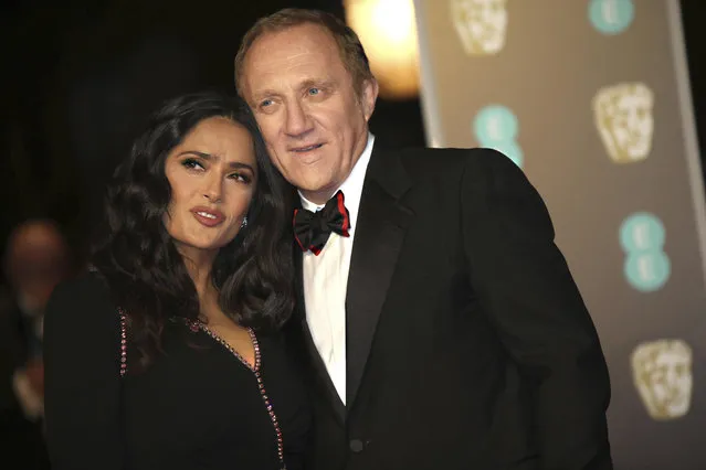 Actress Salma Hayek and husband Francois-Henri Pinault pose for photographers upon arrival at the BAFTA Awards 2018 in London, Sunday, February 18, 2018. (Photo by Vianney Le Caer/Invision/AP Photo)