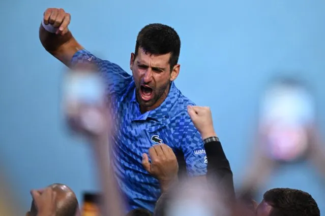 Serbia's Novak Djokovic celebrates his victory against Greece's Stefanos Tsitsipas during the men's singles final on day fourteen of the Australian Open tennis tournament in Melbourne on January 29, 2023. (Photo by Anthony Wallace/AFP Photo)