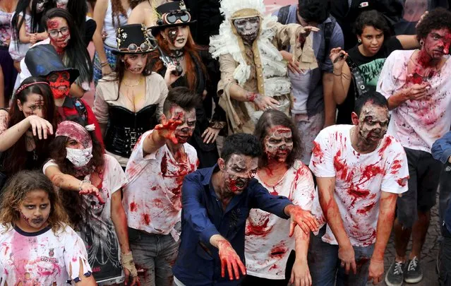 Revellers with their bodies and faces painted attend the "Zombie Walk" parade in Sao Paulo, Brazil, November 2, 2015. (Photo by Paulo Whitaker/Reuters)