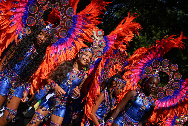 Children in Caribbean-themed costumes take part in the Children's Day Parade, during Notting Hill Carnival, in London, Britain on August 24, 2025. (Photo by Toby Melville/Reuters)