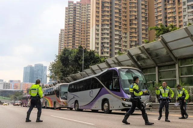Police inspect after an accident on a highway in Hong Kong, Friday, March 24, 2023. Four passenger buses and a truck collided near a Hong Kong road tunnel Friday, injuring dozens of people. (Photo by Louise Delmotte/AP Photo)