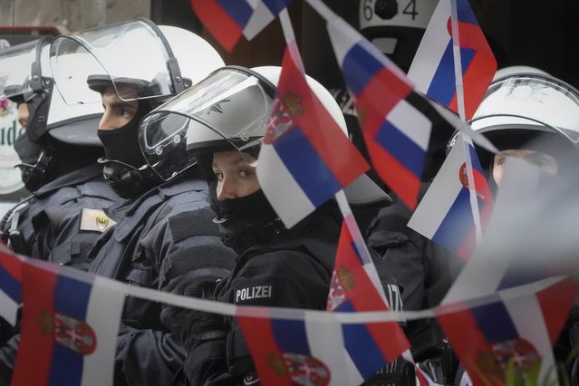 Police stand next to a restaurant decorated with Serbian flags ahead the Group C match between Serbia and England at the Euro 2024 soccer tournament in Gelsenkirchen, Germany, Sunday, June 16, 2024. (Photo by Markus Schreiber/AP Photo)