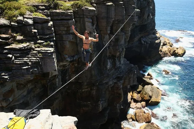 Kyle Beall walks on a slackline between two cliffs at Diamond Bay on December 21, 2014 in Sydney, Australia. (Photo by Cameron Spencer/Getty Images)