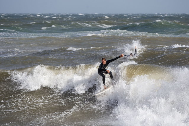 A surfer rides the waves at West Beach as a cold front is forecasted to sweep across southeastern Australia, delivering 10-25mm of rain in Adelaide, Australia, 26 May 2025. (Photo by Matt Turner/EPA)