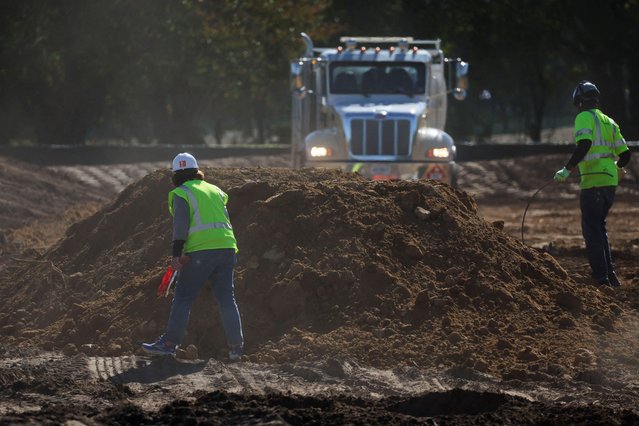 Construction workers walk through soil and debris from the East Wing of the White House demolition, where U.S. President Donald Trump's proposed ballroom is being built, at the East Potomac Golf Course in Washington, D.C., U.S., October 23, 2025. (Photo by Jessica Koscielniak/Reuters)