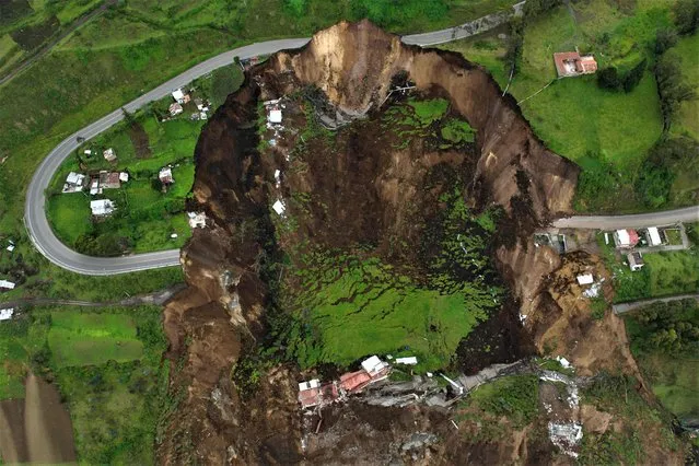 Aerial view of the zone affected by a landslide in Alausi, Ecuador on March 28, 2023. Rescuers searched Monday for more than 60 people reported missing after a landslide triggered by months of heavy rain killed at least seven people in southern Ecuador. The mudslide happened overnight Sunday into Monday, burying dozens of homes and injuring 23 people in the village of Alausi in Chimborazo province, some 300 kilometers (180 miles) south of Quito, officials said. (Photo by Marcos Pin/AFP Photo)