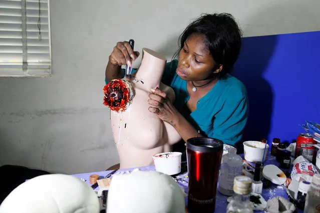Special effects artist Abioye Balogun, 23, works on a mannequin for a Halloween film project in her art studio in Victoria Island, Lagos, Nigeria October 28, 2016. (Photo by Akintunde Akinleye/Reuters)