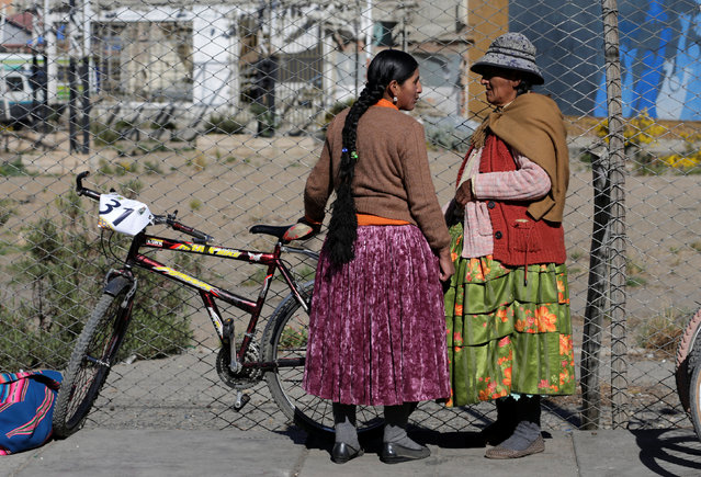 A participant talks with her mother before the Cholita bike race in El Alto, on the outskirts of La Paz, Bolivia, October 29, 2016. (Photo by David Mercado/Reuters)