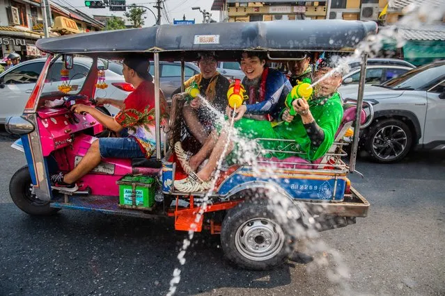 Tourists spray water guns out of a tuk tuk on Khaosan Road during the Songkran festival on April 13, 2023 in Bangkok, Thailand. (Photo by Lauren DeCicca/Getty Images)