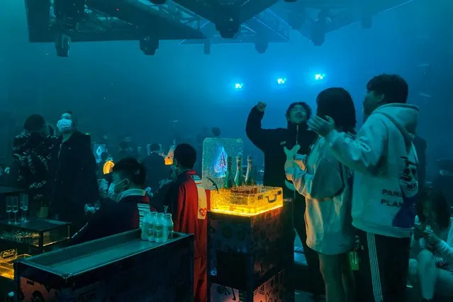 In this picture taken on January 21, 2021, people visit a nightclub in Wuhan, China's central Hubei province. (Photo by Hector Retamal/AFP Photo)