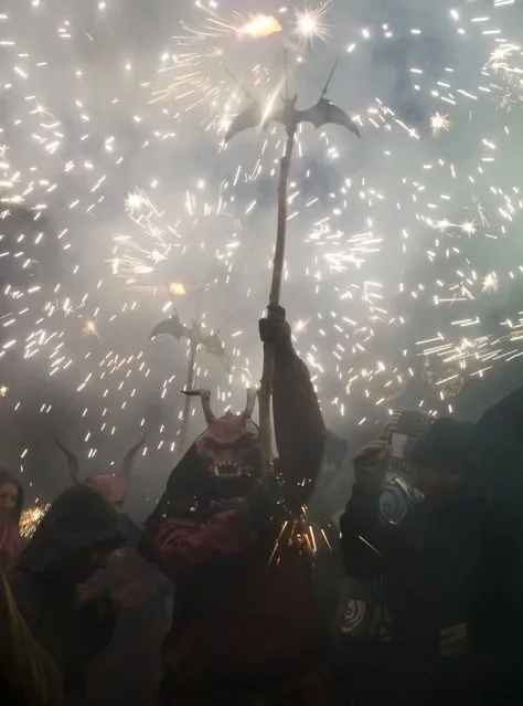 A reveller wearing a demon costume takes part in the traditional festival of “Correfoc” in Palma de Mallorca, on January 17, 2015. (Photo by Jaime Reina/AFP Photo)