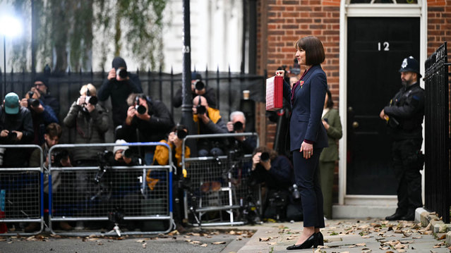 Britain's Chancellor of the Exchequer Rachel Reeves poses with the red Budget Box as she leaves 11 Downing Street, in central London, on October 30, 2024, to present the government's annual Autumn budget to Parliament. Britain's new Labour government unveils its first budget on Wednesday, the highly-anticipated fiscal update, the first under the centre-left government after 14 years of Conservative rule. (Photo by Justin Tallis/Pool via AFP Photo)