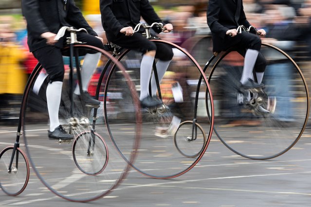 Participants wearing historical costumes ride their high-wheel bicycles during the annual penny farthing race in Prague, Czech Republic on November 2, 2024. (Photo by Eva Korinkova/Reuters)