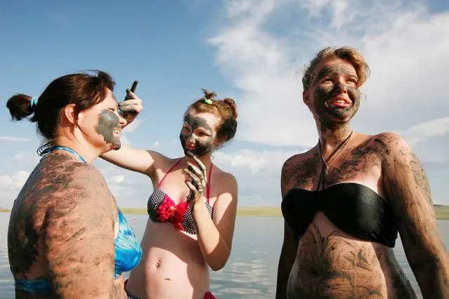 Women smear each other with mineral-rich blue mud on the bank of the Tus lake in Russia's Khakassia region, on July 19, 2013. Russians from different regions annually arrive at the lake to bathe in the bitter-salty water and smear themselves with mud, which is a healing remedy. (Photo by Ilya Naymushin/Reuters)
