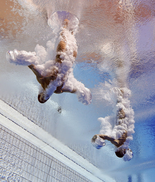 Patrick Hausding and Stephan Feck of Germany compete in the men's 3-meter synchro springboard  preliminary competition at the FINA Swimming World Championships in Barcelona, Spain, Tuesday, July 23, 2013. (Photo by David J. Phillip/AP Photo)