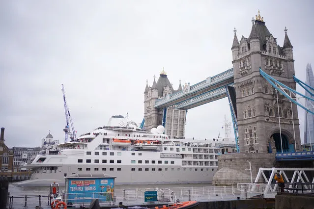 The Silversea Silver Wind cruise ship is guided through Tower Bridge in London on Friday, May 12, 2023, where it had been moored alongside HMS Belfast. (Photo by Yui Mok/PA Images via Getty Images)