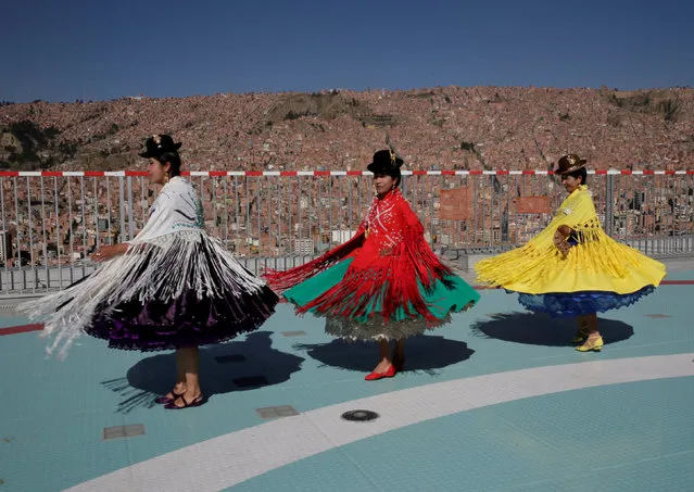 Aymara women dance on the heliport during a tour at the presidential palace La Casa Grande del Pueblo in La Paz, Bolivia, August 18, 2018. (Photo by David Mercado/Reuters)