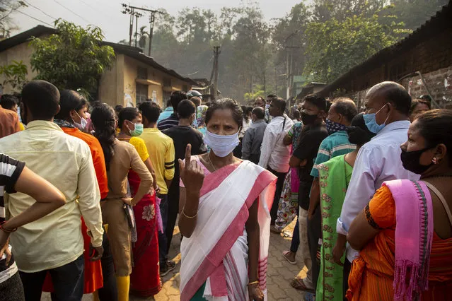 An Assamese voter shows the indelible ink mark on her finger after casting her vote at a polling station during the third phase of assembly election in Gauhati, India, Tuesday, April 6, 2021. Voters in four Indian states and a union territory are casting their ballots, in elections seen as a test for Prime Minister Narendra Modi’s government which is battling the latest surge in coronavirus cases. (Photo by Anupam Nath/AP Photo)