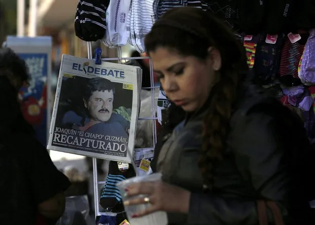 A woman walks past a newspaper showing a photograph of recaptured drug lord Joaquin "Chapo" Guzman on its front page in Culiacan, Mexico, January 9, 2016. (Photo by Daniel Becerril/Reuters)