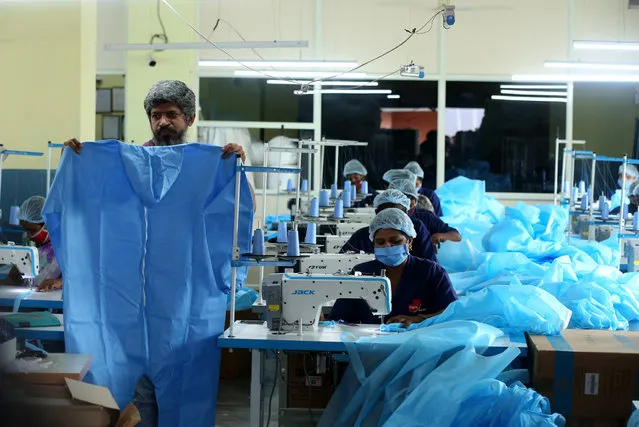 Indian laborers work at the Personal protective equipment (PPE) Kit production factory in Bangalore, India, 06 May 2021. India is the world's second-largest personal protection equipment (PPE) manufacturer and self-reliant amidst COVID19 outbreak. (Photo by Jagadeesh N.V./EPA/EFE)
