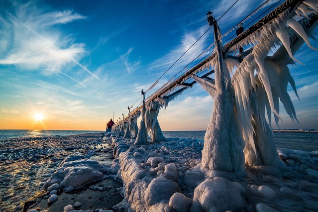 Icicles hang from Grand Haven Pier at sunset. (Photo by Mike Kline/Barcroft Media)