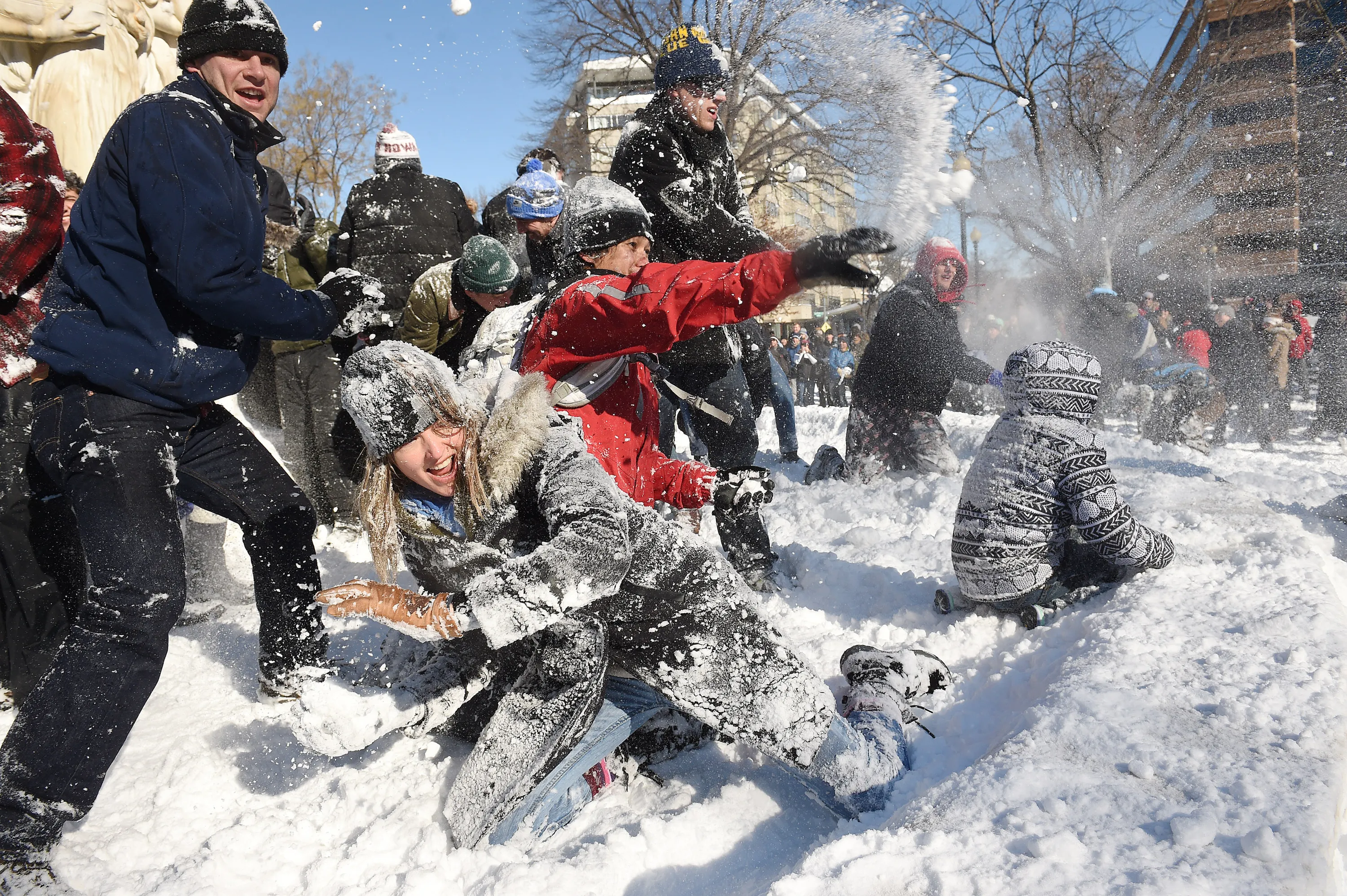 Tamberly Conway, bottom left, takes part in a large snowball fight in Dupon...