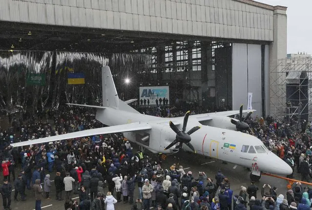People surround a new An-132D cargo plane during its presentation at the Antonov aircraft plant in Kiev, Ukraine, December 20, 2016. (Photo by Valentyn Ogirenko/Reuters)