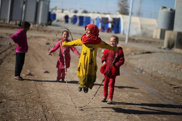 A displaced Iraqi girl plays with a skipping rope in Khazer camp, on the outskirts of Erbil, Iraq December 4, 2016. (Photo by Mohammed Salem/Reuters)