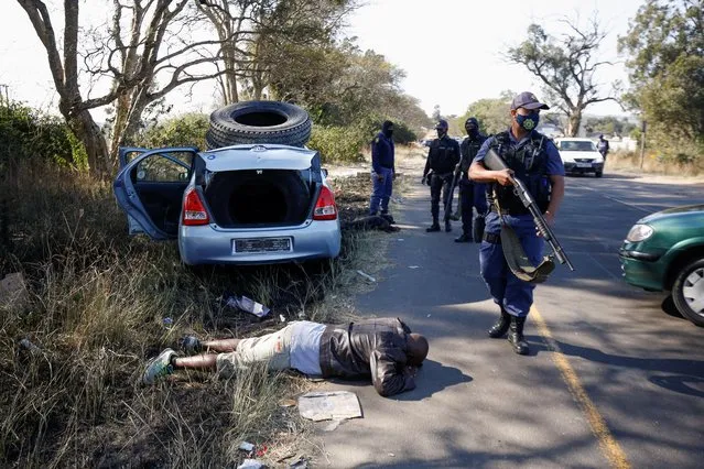 Police officers detain people after violence erupted following the jailing of former South African President Jacob Zuma, in Cato Ridge, South Africa, July 14, 2021. (Photo by Rogan Ward/Reuters)