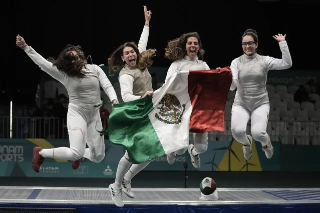 Members of the Mexican women's fencing foil team celebrate their bronze medal victory, at the Pan American Games in Santiago, Chile, Thursday, November 2, 2023. (Photo by Eduardo Verdugo/AP Photo)