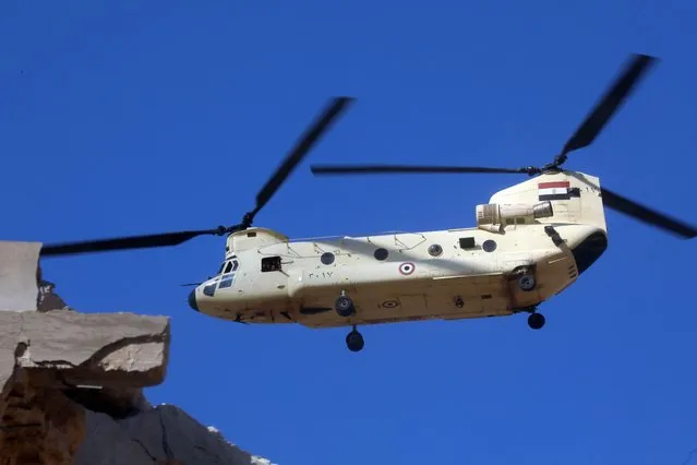An Egyptian military helicopter hovers above affected areas following flash floods in Libya's eastern city of Derna, on September 14, 2023. A global aid effort for Libya gathered pace on September 14 after a tsunami-sized flash flood killed at least 4,000 people, with thousands more missing, a death toll the UN blamed in part on the legacy of years of war and chaos. (Photo by Abdullah Doma/AFP Photo)