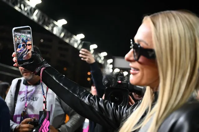 US media personality and businesswoman Paris Hilton takes a selfie as she tours the grid before the start of the Las Vegas Formula One Grand Prix on November 18, 2023, in Las Vegas, Nevada. (Photo by Angela Weiss/AFP Photo)