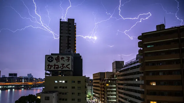 Lightning strikes over Tokyo early on July 4, 2023. (Photo by Philip Fong/AFP Photo)