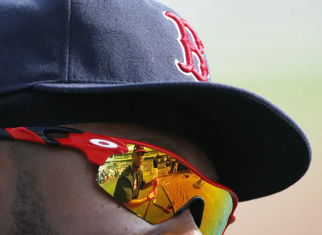 Boston Red Sox' Xander Bogaerts is reflected in teammate Hanley Ramirez's sunglasses before an exhibition spring training baseball game, Wednesday, March 18, 2015, in Fort Myers, Fla. (Photo by Brynn Anderson/AP Photo)