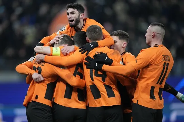 Shakhtar players celebrate after teammate Mykola Matviyenko scored the opening goal during the Champions League group H soccer match between Shakhtar Donetsk and Antwerp at Volksparkstadion in Hamburg, Germany, Tuesday, November 28, 2023. Shakhtar won 1-0. (Photo by Martin Meissner/AP Photo)
