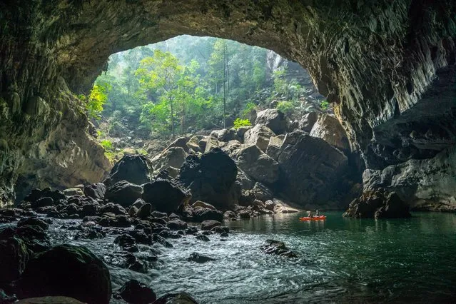 The upstream inflow entrance of Tham Khoun Xe has a verdant forest inside a huge collapsed doline. It is possible to kayak from the resurgence to here and back in one full day. There are several more kilometers of cave in an adjacent fossil passage that visitors can access by climbing the boulder pile. on March 2015 at Tham Khoun Ex, Laos. (Photo by John Spies/Barcroft Media/ABACAPress)