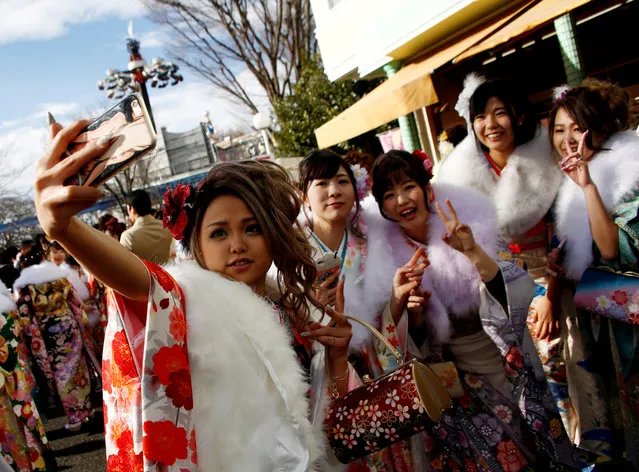 Japanese women wearing kimonos take a 'selfie' after their Coming of Age Day celebration ceremony at an amusement park in Tokyo, Japan January 9, 2017. (Photo by Kim Kyung-Hoon/Reuters)