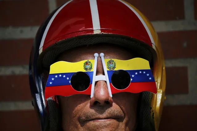 An anti-government protester wears Venezuelan flag motif sunglasses during a demonstration demanding the resignation of President Nicolas Maduro, in Caracas, Venezuela, Saturday, February 2, 2019. Momentum is growing for Venezuela's opposition movement led by self-declared interim president Juan Guaido, who has called supporters back into the streets for nationwide protests Saturday, escalating pressure on Maduro to step down. (Photo by Fernando Llano/AP Photo)