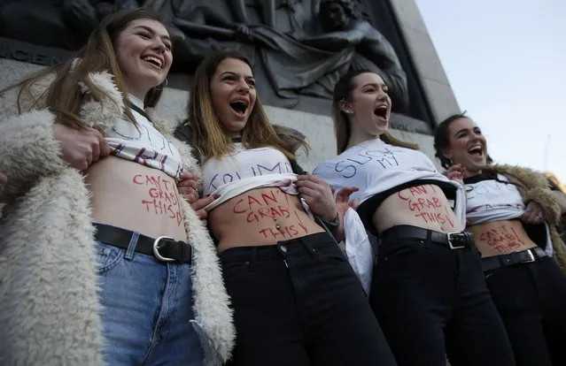 Protesters display their body graffiti as they take part in the Women's March on London, as they stand in Trafalgar Square, in central London, Britain January 21, 2017. The march formed part of a worldwide day of action following the election of Donald Trump to U.S. President. (Photo by Neil Hall/Reuters)