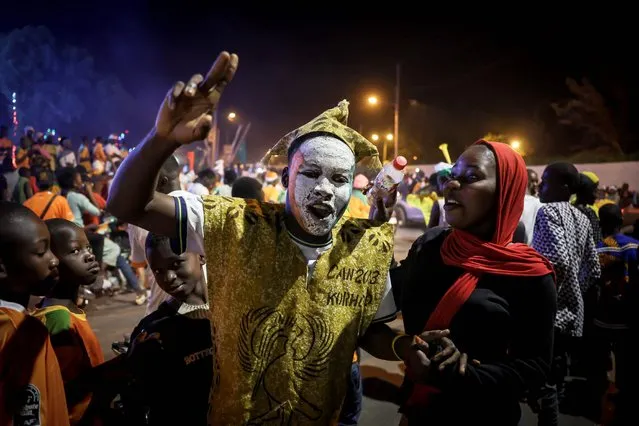 Ivorian supporters parade down the street in Korhogo, northern Ivory Coast, on January 13, 2024, atfer the Ivory coast footnall team won the football match between Ivory Coast and Guinea-Bissau during the 2024 Africa Cup of Nations (CAN). (Photo by Fadel Senna/AFP Photo)