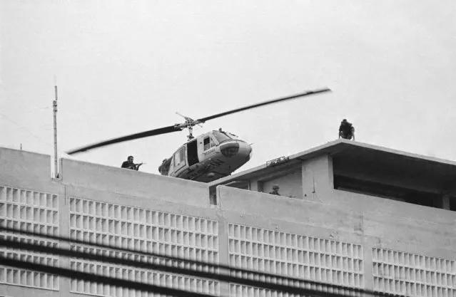 A U.S. Marine helicopter takes off from helipad on top of the American Embassy in Saigon, Vietnam, April 30, 1975. (Photo by AP Photo/Phuoc)