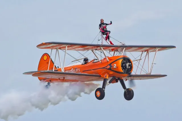 Wingwalkers from the Aerosuperbatics team at the Eastbourne annual airshow on August 15, 2019. Thousands of visitors attend this popular air show on the UK South coast. Flying displays and ground based entertainments form this four day event. (Photo by Alan Fraser/Alamy Live News)