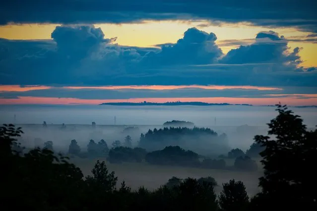 The fog lifts at sunrise in Principalis Valley, near Zalaszentbalazs, Hungary, 24 August 2021. (Photo by Gyorgy Varga/EPA/EFE)