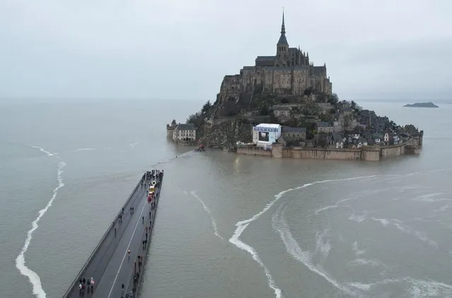 A drone view shows Mont Saint-Michel surrounded by sea during a high tide, in the French western region of Normandy, France, on March 12, 2024. (Photo by Stephane Mahe/Reuters)