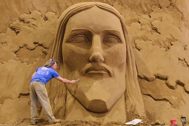 Sand sculptor Dan Belcher of the USA works on sand sculpture named Christ the Redeemer statue in Corcovado, ahead of the eight annual exhibition “World Travel By Sand – South Africa” at the Tottori Sand Dunes The Sand Museum on March 30, 2016 in Tottori, Japan. The exhibition will be available to the public from April 16, 2016 to January 3, 2017. (Photo by Buddhika Weerasinghe/Getty Images)